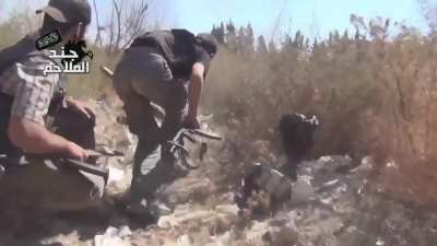 FSA fighters advance at a crouch while under fire towards Syrian Army held positions - al-Qasimiya, Damascus - 10/15/2013