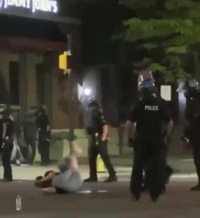 Girl being maced and kicked by police as she is peacefully protesting.