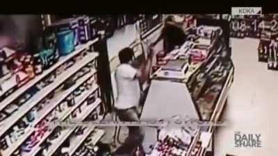 Robber pulls out machete; Clerk pulls out sword