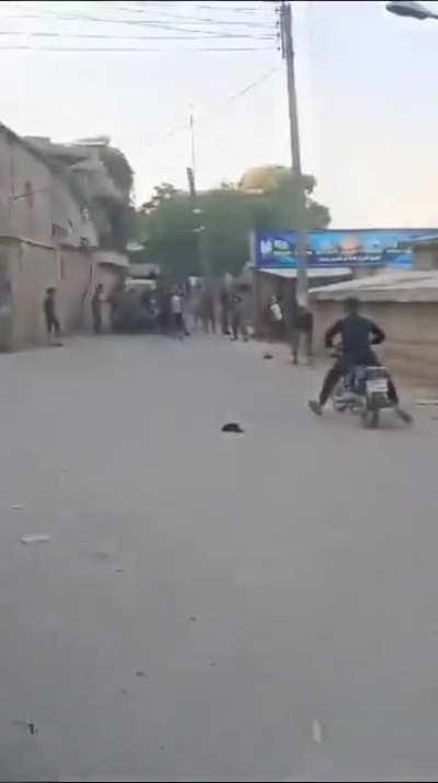 Armed Syrian National Army (TFSA) protestors clash with Turkish Armed Forces. Several wounded protestors are carried away by other protestors.