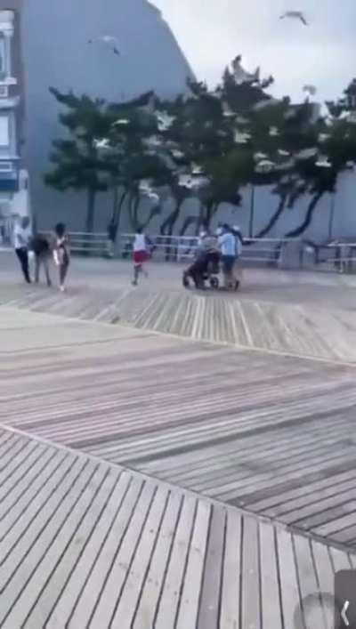 Man being chased by seagulls that want his food