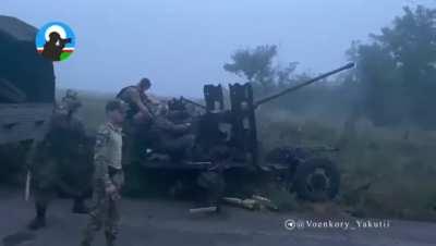 Russian crew firing AZP S-60. A Soviet towed, road-transportable, short- to medium-range, single-barrel anti-aircraft gun from the 1950s. Unknown location.