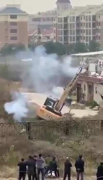 Man in China uses fireworks to fight off bulldozer sent to demolish his building