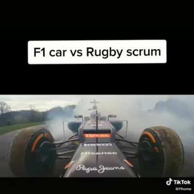 Rugby scrummers generate enough horsepower to hold back F1 car.