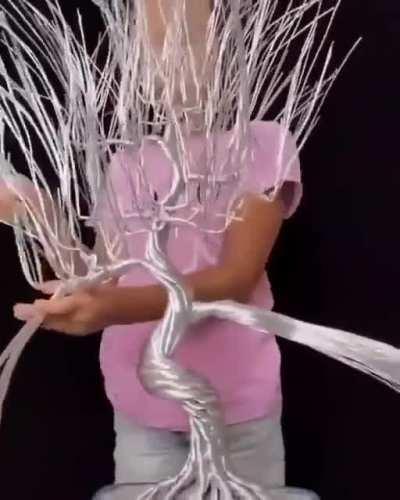 This girl makes wire-wrapped trees, complete with blossom