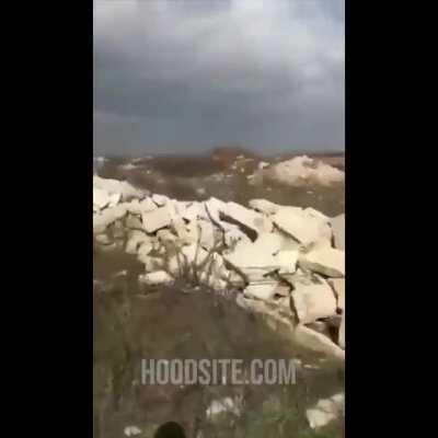 Syrian man documenting a battle site in Idlib steps on an IED/unexploded ordnance