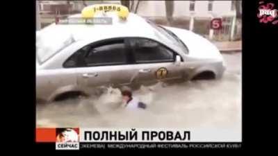 WCGW doing a news report next to a flooded street