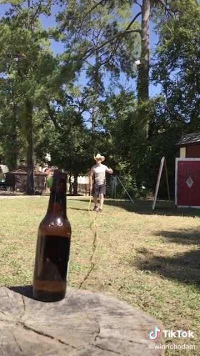 Opening beer bottle with thirty foot bull whip