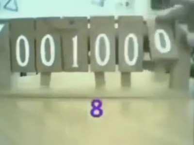 Mechanical binary count with small piece of wood at the top acting as a transport bit.