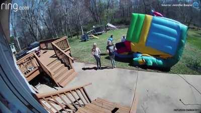 5 year old almost gets hit by bounce house swept away by a gust of wind because its not securely mounted.