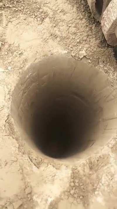 Construction worker going into a deep hole