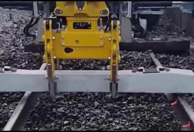 A rail excavator attachment that turns it into a high-performance sleeper changer without removing the rails.