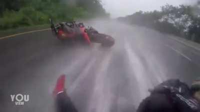 Guy gets into motorbike accident on a flooded road and elegantly saves girlfriend.