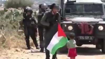 A Palestinian father sends his child to confront soldiers in order to film a propaganda video