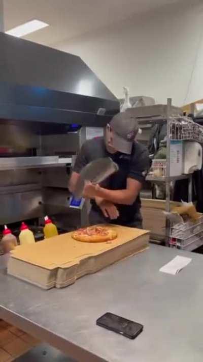 This is how you cut a pizza smoothly . He love his job