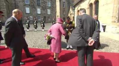 Pony tries to eat the Queen's flowers at Stirling Castle but she gently boops its snoot