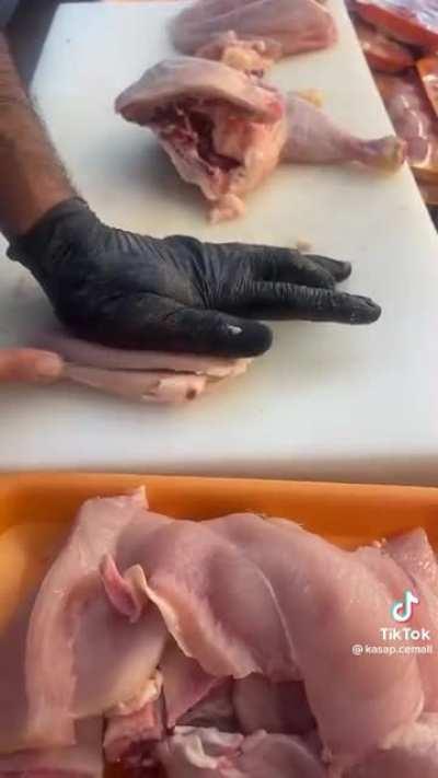 Cutting chicken into pieces.