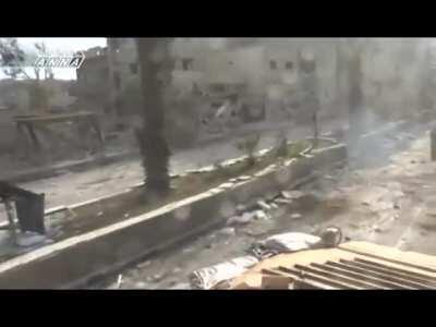 Syrian Army BMP delivers suppressing fire into buildings while moving through Daraya - 2013