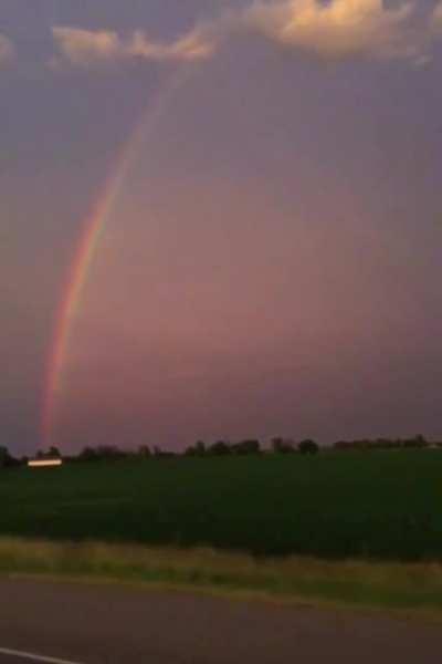 Rainbow with lightning striking past it. Very mesmerising.