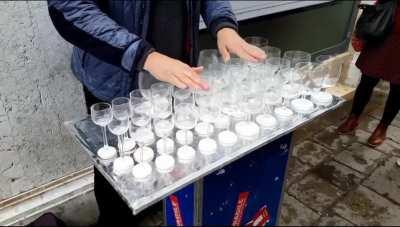 Street performance with wine glasses 