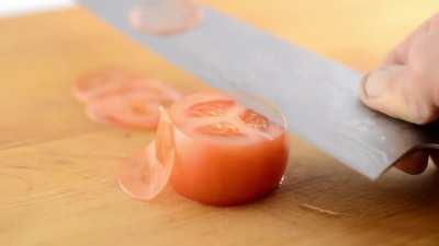 Testing my newest knife on a tomato after sharpening it.