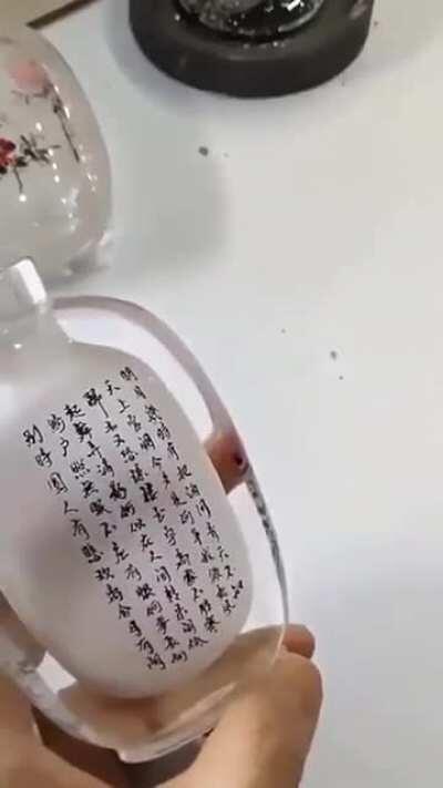 Perfect handwriting inside a frosted glass bottle