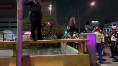 A Mexican police man stops a suicide attempt, on a bridge, with no safety equipment.