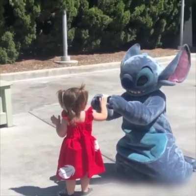 Little girl falls so Stitch does too