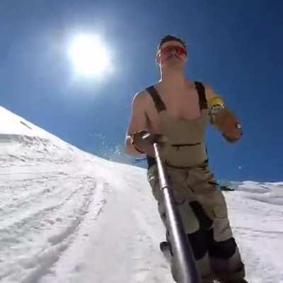 Taking a drink while doing a flip on a ski slope