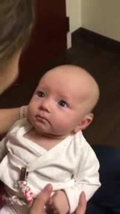 A baby first time listening to his mother, with the help of hearing aids.