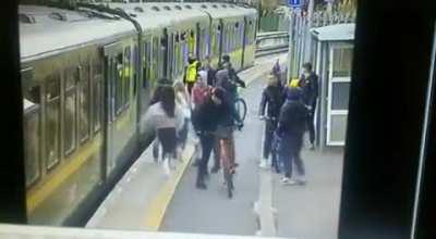 young girl being pushed on to a train track