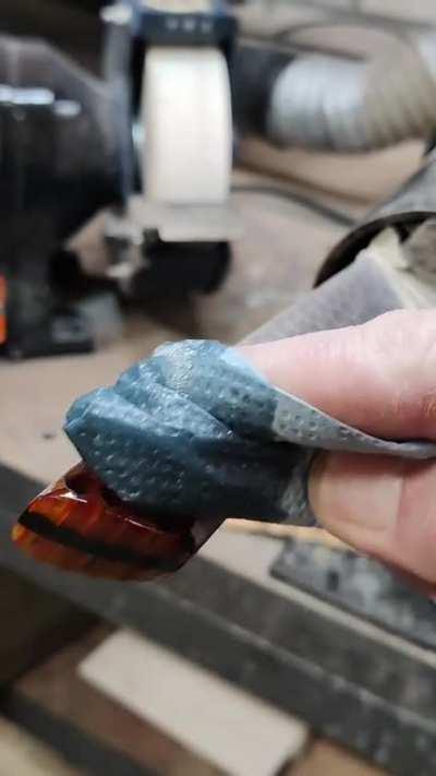 Putting oil on a fresh knife handle.