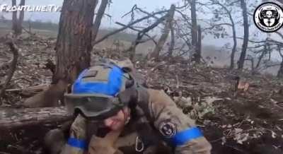 An American volunteer from the &quot;Kenobi Death Korps&quot; unit (1st Battalion of the International Legion) resques a wounded Canadian volunteer in Ukraine