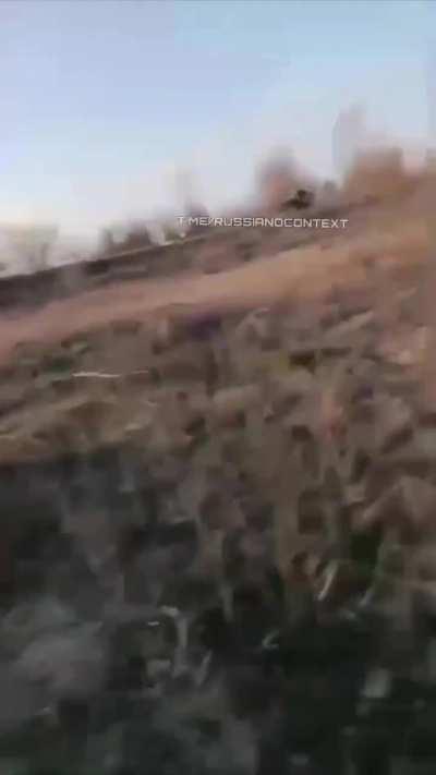 A Russian soldier films from the ground how a Ukrainian FPV drone hits another Russian soldier.