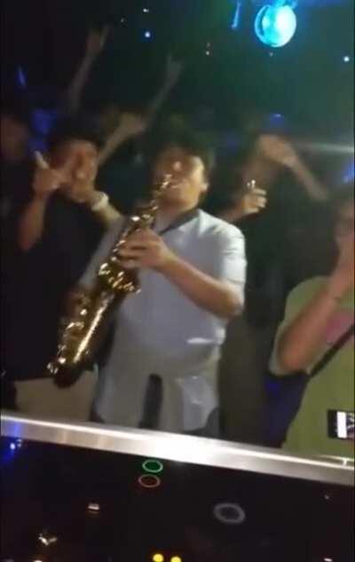 Epic saxophone performance from an audience makes everyone have a good time