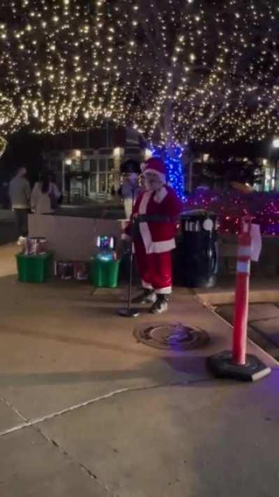 Drunk santa doesn’t know the words to whatever he’s singing.