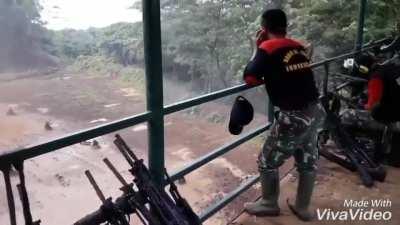 Indonesian soldiers training to crawl under live fire