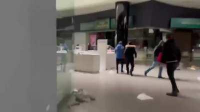 Looting going on in the mall of Mariuopol and the guy filming is trying to stop them | today