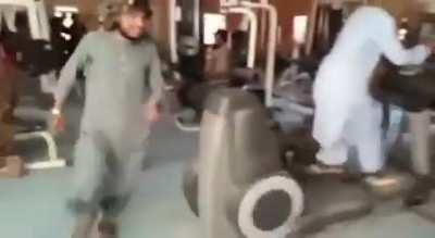 Taliban fighters discover a gym for the first time on an American base