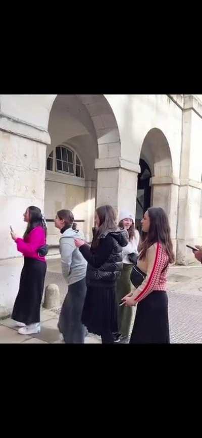 American tourists harass a Queens Guard.