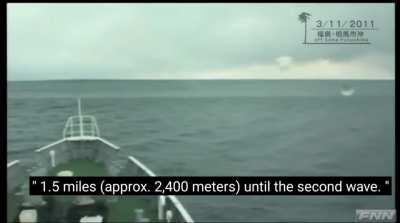 Japanese coast guard patrol boat encountering a giant tsunami off the coast of Fukushima prefecture after a massive earthquake on 11th March 2011