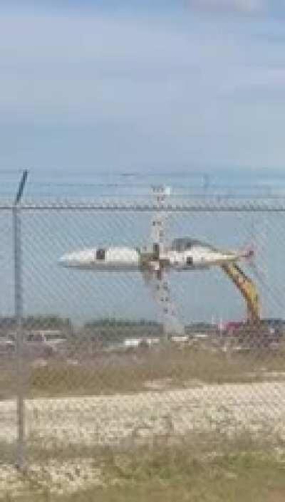 crane moving an airplane like a toy