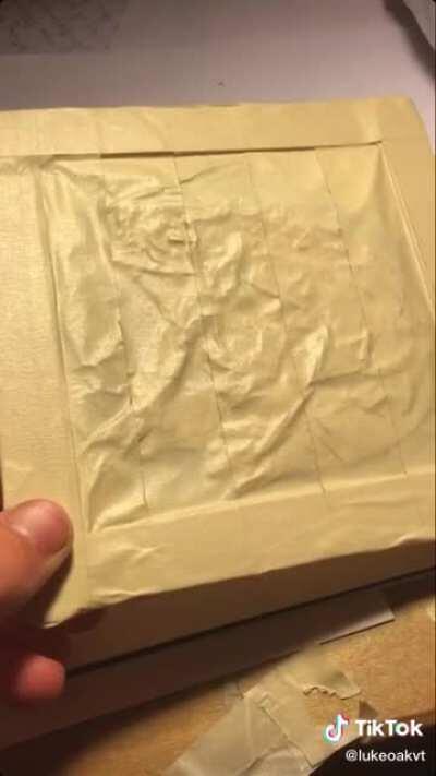 Guy creates a frog silhouette using only ripped/cut pieces of tape