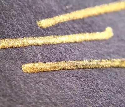 Macro video of gold ink as it dries