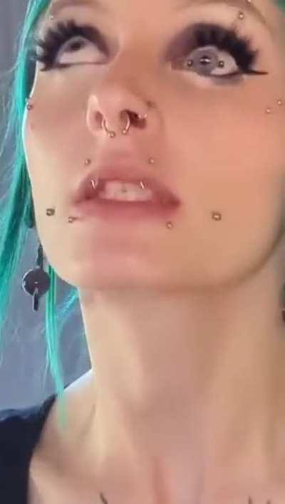 Woman with facial piercings has an iris piercing