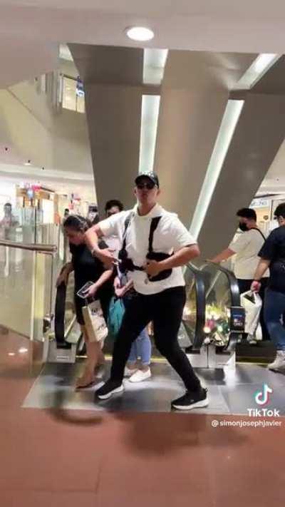 Dancing in front of an escalator being an inconvenience and a potential cause of accident just for the Tiktok views