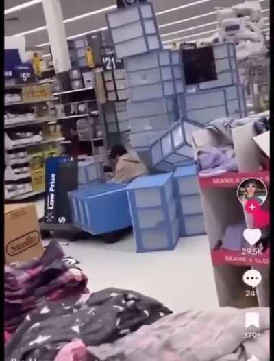 Boys knock off stacked containers at a Walmart for a TikTok video