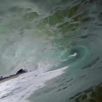 This photographer got a video of a wave crashing over him: