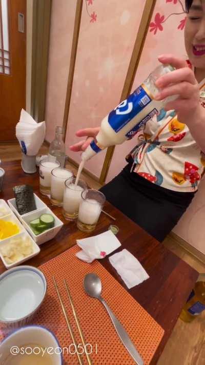 Korean hostess serves a soju and beer mix