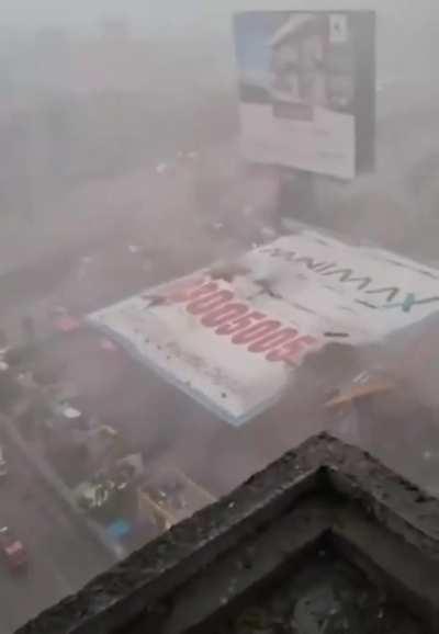 A giant billboard fell and crashed into a gas station during a storm. 